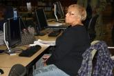 Image: A woman listens intently during a computer basics class