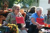 Image: Caron Warner and Mary Ruth Raines ride a float to promote the new center