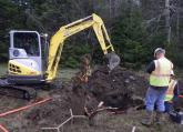 ION crew members dig a hole for the project’s new broadband fiber