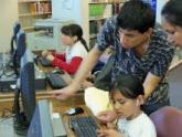 Lincoln Heights instructor Mario Martinez provides assistance to a young student