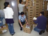 Volunteers unpack new computers