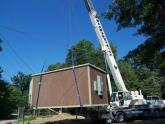A MBC crew installs a pre-fabricated hut