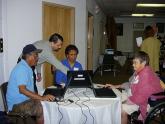 library staff helping people use computers