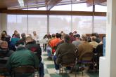 IMG: Individuals bidding on construction contracts sit at pre-bid meeting