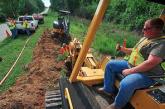 A worker directs a construction drill.