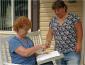 Image: Staff member conducts a survey with a community member