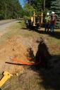 Workers discuss the positioning of a fiber-optic cable segment