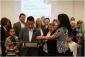 IMG: John Munoz and library members participate in a ribbon-cutting