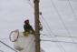 NTUA crews get lifted up to install new fiber lines.