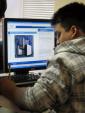 IMG: A student at the Latin American Youth Center receives IT training