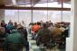 IMG: Individuals bidding on construction contracts sit at pre-bid meeting