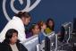 Four women learn computer basics from a Youth Policy instructor