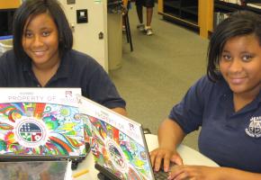 Two students use loaner laptops at one of the project’s upgraded centers
