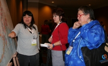 Image: Launch attendees review a map of the 104 Alaska OWL libraries. 