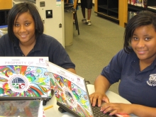 Two students use loaner laptops at one of the project’s upgraded centers